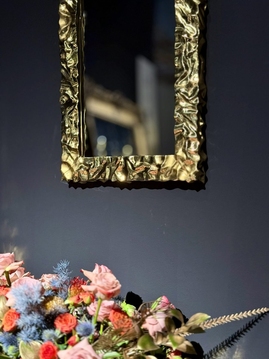 Brass framed mirror with cast ornament